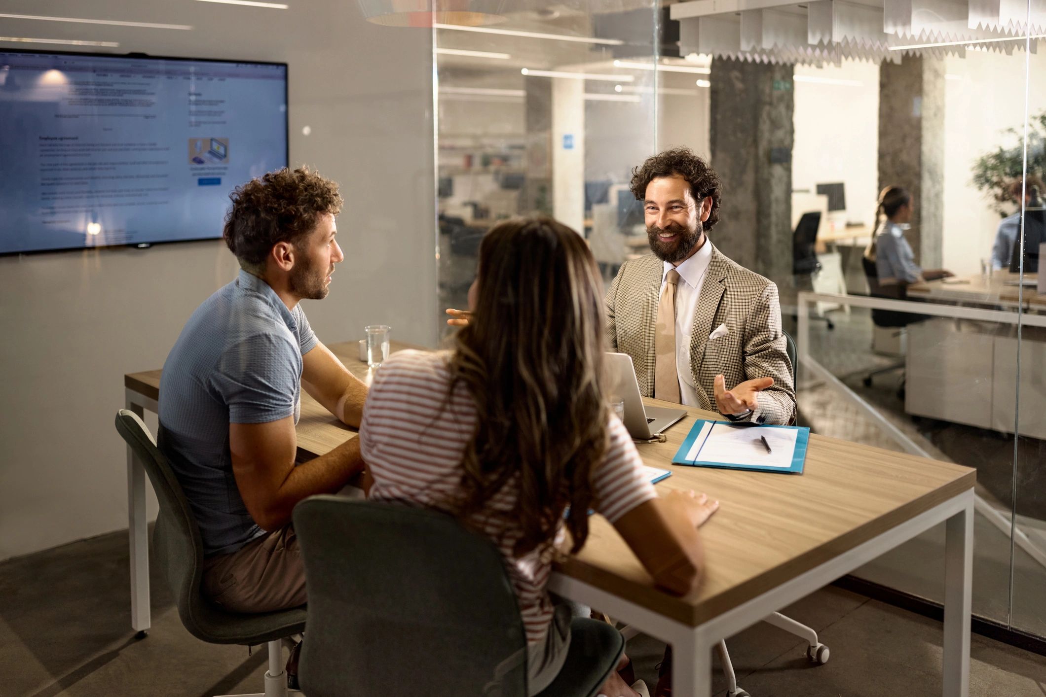 Advisor speaking with clients in an office